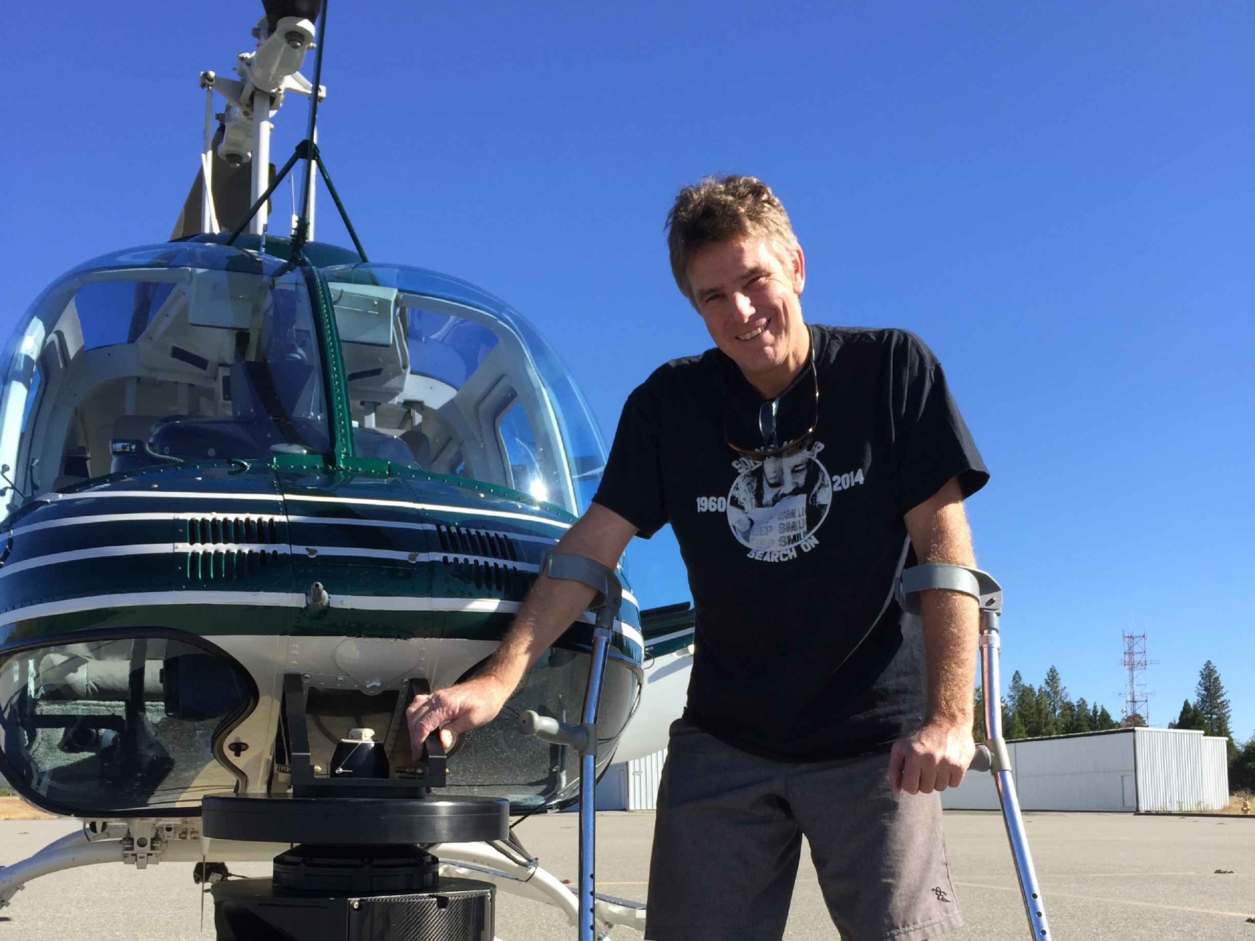 Man in front of helicopter